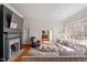 Comfortable living room featuring a brick fireplace, large windows, and plush seating, perfect for relaxation at 2602 Vintage Hill Ct, Durham, NC 27712