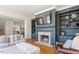 Comfortable living room featuring a brick fireplace, built-in shelving, and plush seating for relaxation at 2602 Vintage Hill Ct, Durham, NC 27712