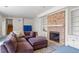 Stylish living room featuring brick fireplace, neutral carpet and comfortable seating at 2602 Vintage Hill Ct, Durham, NC 27712