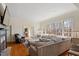 Bright living room featuring a brick fireplace, large windows, and plush seating for a cozy atmosphere at 2602 Vintage Hill Ct, Durham, NC 27712
