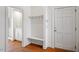 Bright mudroom with built-in bench, coat hooks and view to a bathroom at 2602 Vintage Hill Ct, Durham, NC 27712