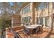 Brick patio area with table and chairs, offering outdoor seating with great light at 2602 Vintage Hill Ct, Durham, NC 27712