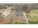 Aerial view of property showcasing the residence, lush landscaping, and surrounding trees and farmland at 3068 Benson Rd, Angier, NC 27501