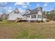 Exterior view of the house, featuring a well-maintained yard with a deck for outdoor activities at 3068 Benson Rd, Angier, NC 27501