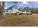 Charming white house showcasing a lovely backyard, perfect for outdoor gatherings and relaxation at 3068 Benson Rd, Angier, NC 27501