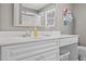 Well-lit bathroom featuring a modern sink, vanity, and large mirror at 3068 Benson Rd, Angier, NC 27501