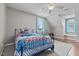 Comfortable bedroom with a patterned quilt, hardwood floors, and plenty of natural light at 3068 Benson Rd, Angier, NC 27501