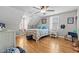 Cozy bedroom with hardwood floors, a ceiling fan, and natural light at 3068 Benson Rd, Angier, NC 27501