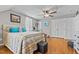 Bright bedroom featuring a ceiling fan, hardwood floors, and storage at 3068 Benson Rd, Angier, NC 27501