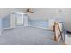 Spacious bonus room with blue walls, carpet and ceiling fan at 3068 Benson Rd, Angier, NC 27501
