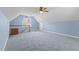 Spacious bonus room with blue walls, carpet and ceiling fan at 3068 Benson Rd, Angier, NC 27501