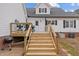 Wooden deck and stairs lead to a cozy outdoor space for entertaining and relaxation in the backyard at 3068 Benson Rd, Angier, NC 27501