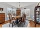 Bright dining room with hardwood floors and a chandelier above the table at 3068 Benson Rd, Angier, NC 27501