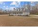 Charming two-story home with a large front yard and covered porch at 3068 Benson Rd, Angier, NC 27501