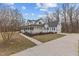 Spacious two-story home featuring a wraparound porch and a long driveway at 3068 Benson Rd, Angier, NC 27501
