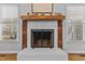 Close up of the fireplace with a wooden mantle and a decorative display above at 3068 Benson Rd, Angier, NC 27501
