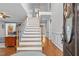 Elegant foyer with a staircase, hardwood floors, and a view into the living room at 3068 Benson Rd, Angier, NC 27501