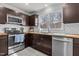 Kitchen with stainless steel appliances, wooden countertops, and tile backsplash at 3068 Benson Rd, Angier, NC 27501