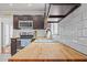 The kitchen features butcher block countertops and stainless steel appliances at 3068 Benson Rd, Angier, NC 27501
