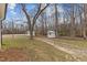 Outdoor buildings on the property, set among mature trees at 3068 Benson Rd, Angier, NC 27501
