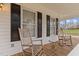Inviting front porch with wooden rocking chairs and detailed woodwork at 3068 Benson Rd, Angier, NC 27501