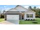 Charming single-Gathering home features a brick-accented garage and well-manicured lawn at 31 Black Creek Dr, Lillington, NC 27546