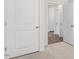 Hallway with transitions from carpet to wood floors, creating a layered feel at 31 Black Creek Dr, Lillington, NC 27546