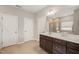 Bright bathroom featuring a dark wood vanity with a large mirror, tiled floors, and an open layout at 3356 Longleaf Estates Dr, Raleigh, NC 27616