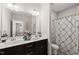 Double vanity bathroom with dark cabinets and a separate shower at 3356 Longleaf Estates Dr, Raleigh, NC 27616