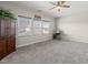 Bedroom with neutral carpet, ceiling fan and a view of three windows at 3356 Longleaf Estates Dr, Raleigh, NC 27616