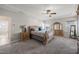Spacious bedroom featuring a ceiling fan, carpeted floor and stylish furniture creating a cozy atmosphere at 3356 Longleaf Estates Dr, Raleigh, NC 27616