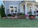 Charming home featuring a well-maintained lawn and a beautiful flower bed adding vibrant colors to the front yard at 3356 Longleaf Estates Dr, Raleigh, NC 27616