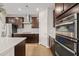 Modern kitchen featuring stainless steel appliances, dark cabinets and an eat-in island at 3356 Longleaf Estates Dr, Raleigh, NC 27616