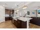 Open concept kitchen with large island, stainless steel sink and appliances, opening to the Gathering room at 3356 Longleaf Estates Dr, Raleigh, NC 27616