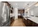 Spacious kitchen with stainless steel appliances, large island and dark wood cabinets at 3356 Longleaf Estates Dr, Raleigh, NC 27616