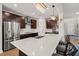 Modern kitchen features a large island, stainless steel appliances, dark wood cabinets and elegant lighting at 3356 Longleaf Estates Dr, Raleigh, NC 27616