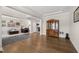 Spacious open-concept living area with hardwood floors and elegant display cabinet at 3356 Longleaf Estates Dr, Raleigh, NC 27616