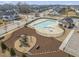 Aerial view of a neighborhood pool, clubhouse, and playground in a residential community at 3356 Longleaf Estates Dr, Raleigh, NC 27616