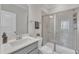 Well-lit bathroom featuring a glass-enclosed shower, sleek fixtures, and a modern design at 372 Natsam Woods Way, Wake Forest, NC 27587