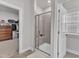 Bright bathroom featuring a glass-enclosed shower with tiled walls and a small seating area at 372 Natsam Woods Way, Wake Forest, NC 27587