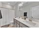 Well-lit bathroom featuring double sinks, a large mirror, and neutral decor at 372 Natsam Woods Way, Wake Forest, NC 27587