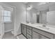 Well-lit bathroom featuring double sinks, a large mirror, and modern fixtures at 372 Natsam Woods Way, Wake Forest, NC 27587