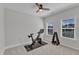 Bright bedroom with large windows, a ceiling fan, exercise equipment and neutral decor at 372 Natsam Woods Way, Wake Forest, NC 27587