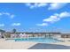 A community pool surrounded by neighborhood townhomes and blue skies at 372 Natsam Woods Way, Wake Forest, NC 27587