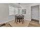 Dining area with square table, four chairs, light fixture and wall art at 372 Natsam Woods Way, Wake Forest, NC 27587