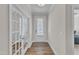 Bright entryway featuring hardwood floors, neutral paint, and a glimpse into adjacent rooms at 372 Natsam Woods Way, Wake Forest, NC 27587