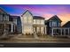 Sunset view of neighborhood homes showcasing their charming facades and inviting curb appeal at 372 Natsam Woods Way, Wake Forest, NC 27587