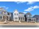 Street view showcasing charming homes with inviting front porches and well-manicured landscaping at 372 Natsam Woods Way, Wake Forest, NC 27587