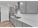 Kitchen features stainless appliances, grey cabinets and white subway tile at 372 Natsam Woods Way, Wake Forest, NC 27587