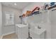 Well-lit laundry room with front load washer, utility sink, drying rack and plenty of storage space at 372 Natsam Woods Way, Wake Forest, NC 27587